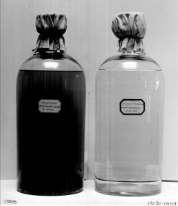 Two bottle of water, one before filtration and one after.